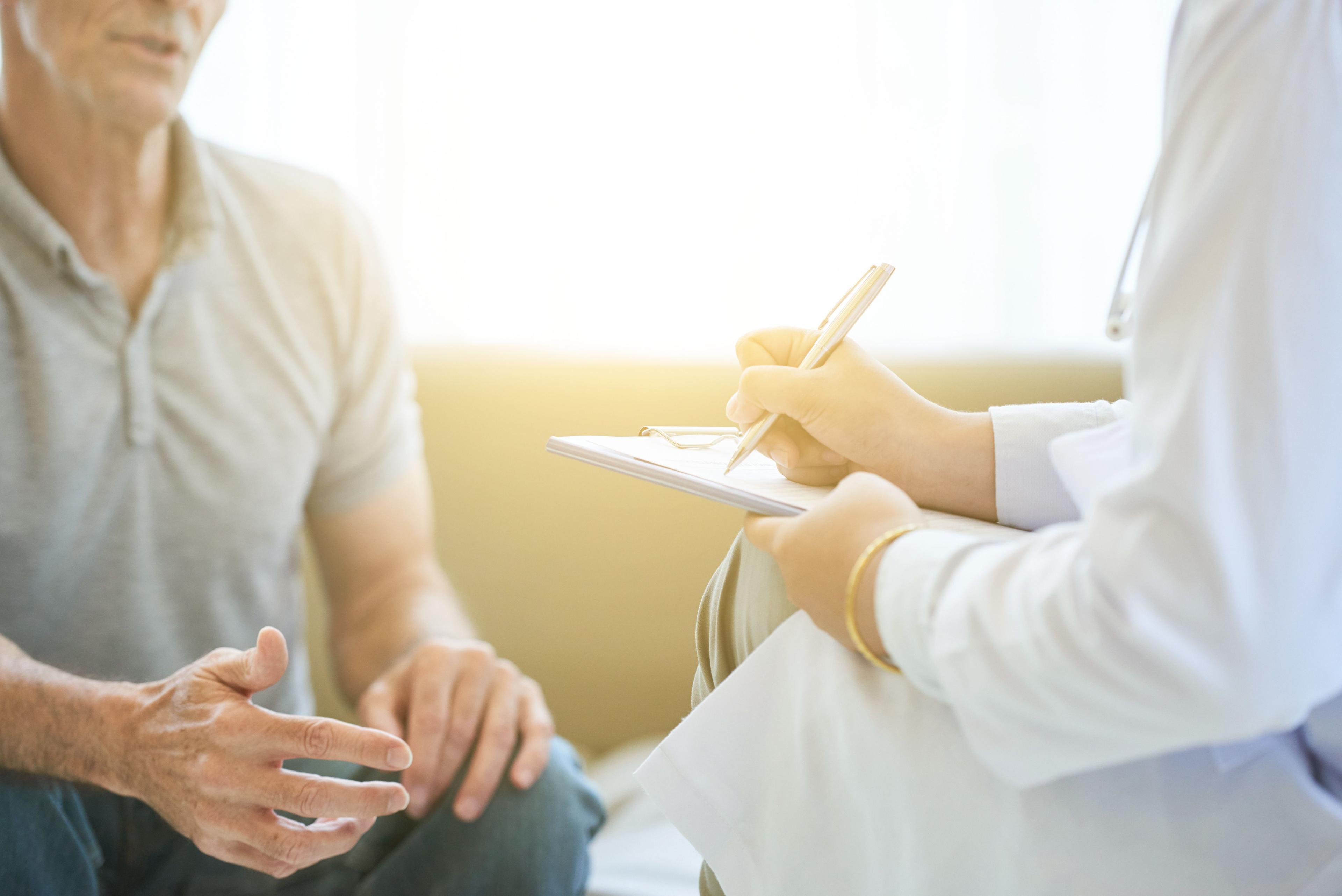 Doctor counseling older male patient